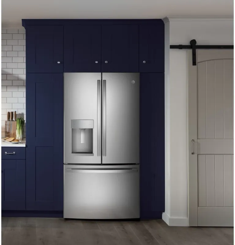 A stainless steel refrigerator that is hooked up in a kitchen